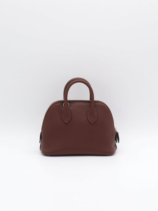 Dome-shaped top-handle handbag in deep burgundy grained leather with silver-tone zip and twin rolled handles