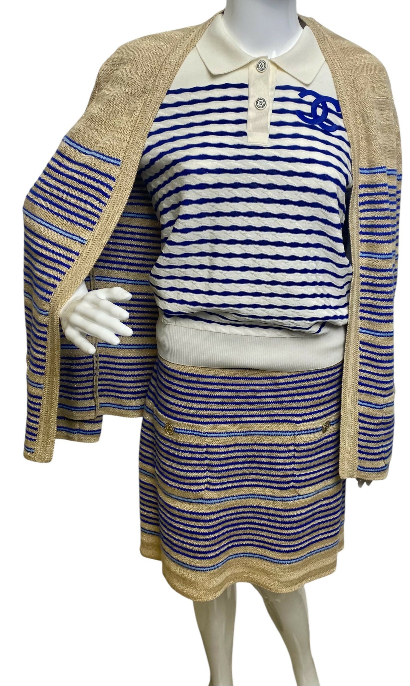 From the 2019 Cruise Resort La Pausa Collection by Karl Lagerfeld. Set Retail 5.5k Chanel Outfit in Metallic Striped Cardigan in Gold, Beige, and Blue Striped Linen Cashmere Blend with Matching Skirt. 2 Gold CC Buttons on Pockets and 2 on the skirt with