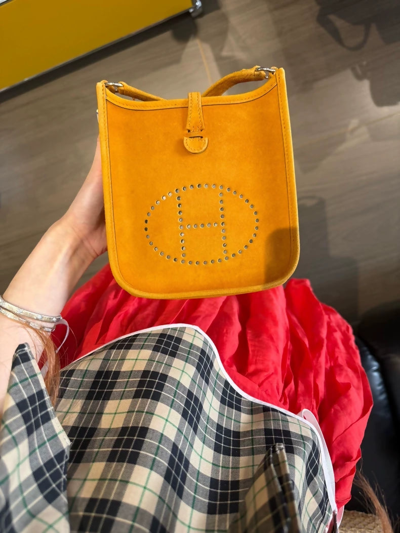 The Hermès Evelyen mini bag in turmeric orange suede is extremely rare!