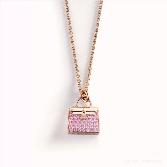 Hermès Kelly bag diamond and pink sapphire pendant necklace