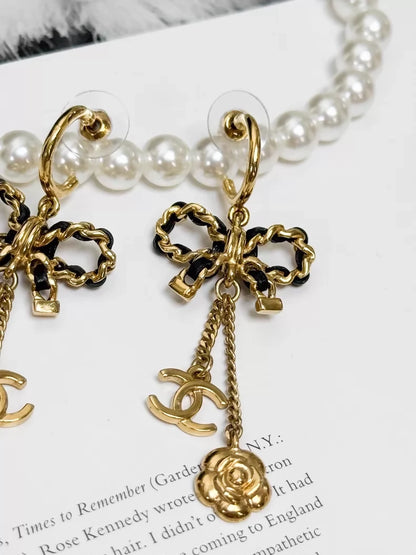 Chanel Métiers d'Art black and gold leather chain with bow earrings