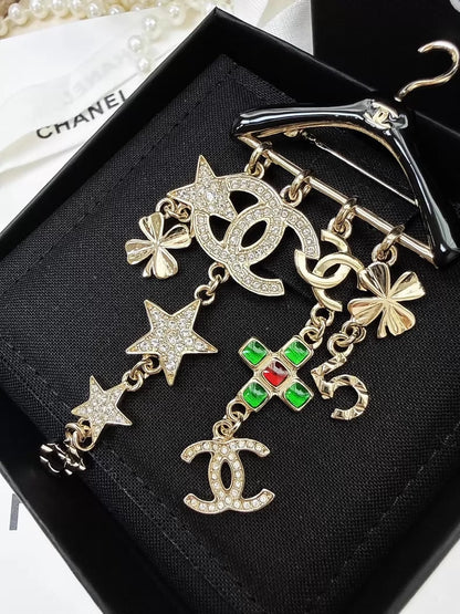 Chanel 23C black and gold hanger brooch