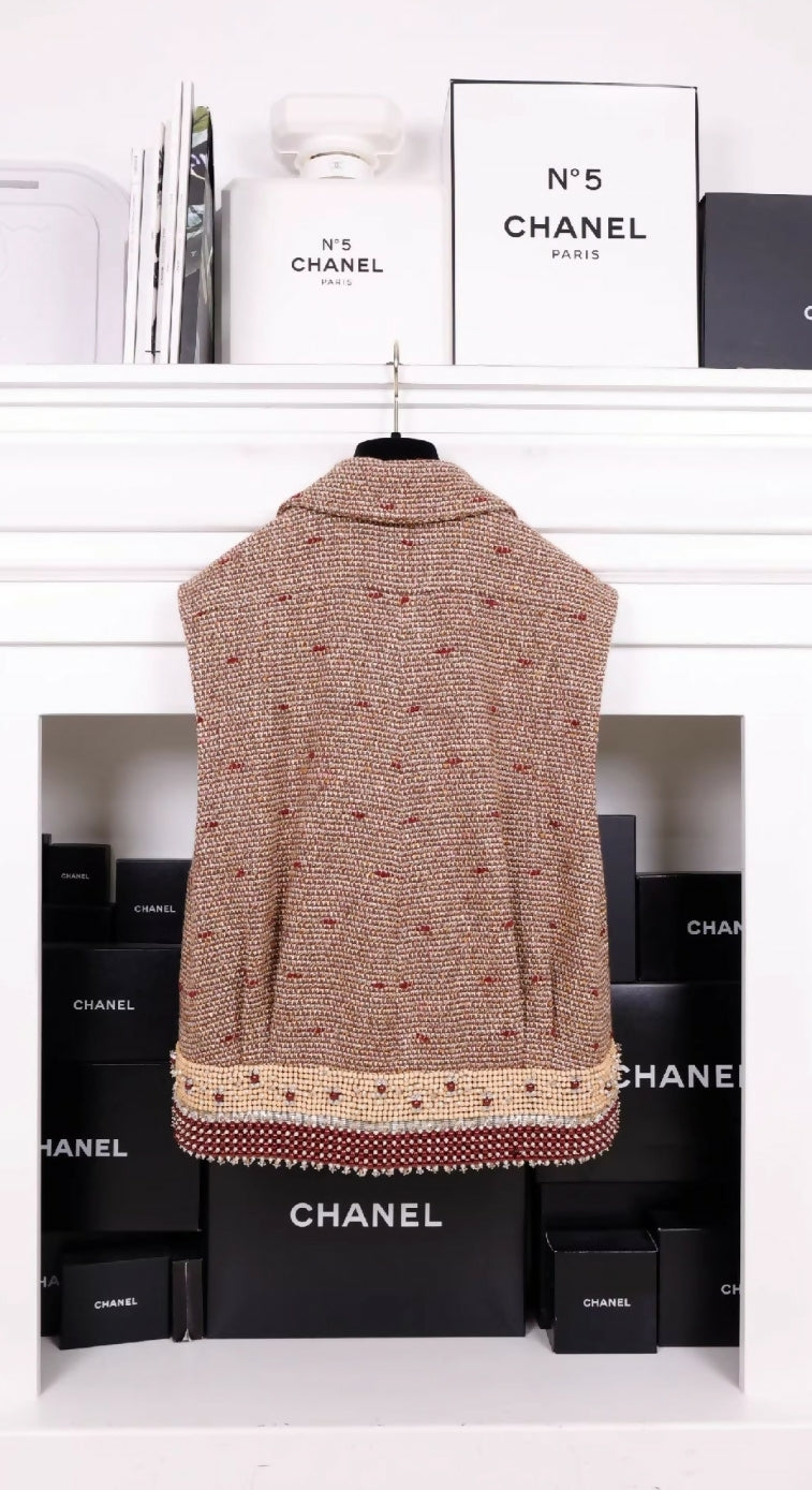 Chanel 23A Dakar Collection Show Style, the same style worn by Wang Yibo. Brown, two-pocket vest with heavy beaded trim.