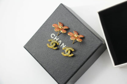 Chanel 03P Enamel Orange Five-Petal Flower Green CC Stacked Earrings