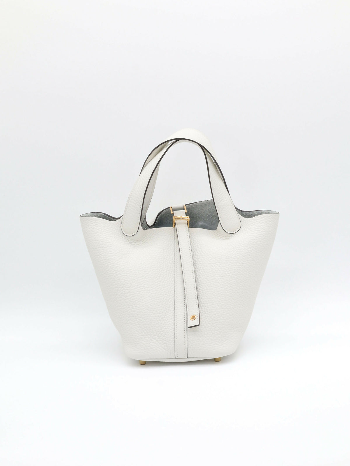 White bucket bag in grained leather with gold-tone hardware, twin rolled handles and front strap closure