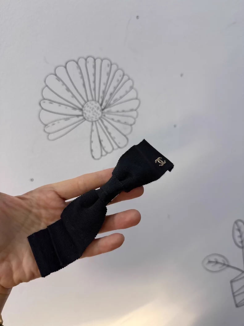 Chanel's classic black bow double-C hair clip