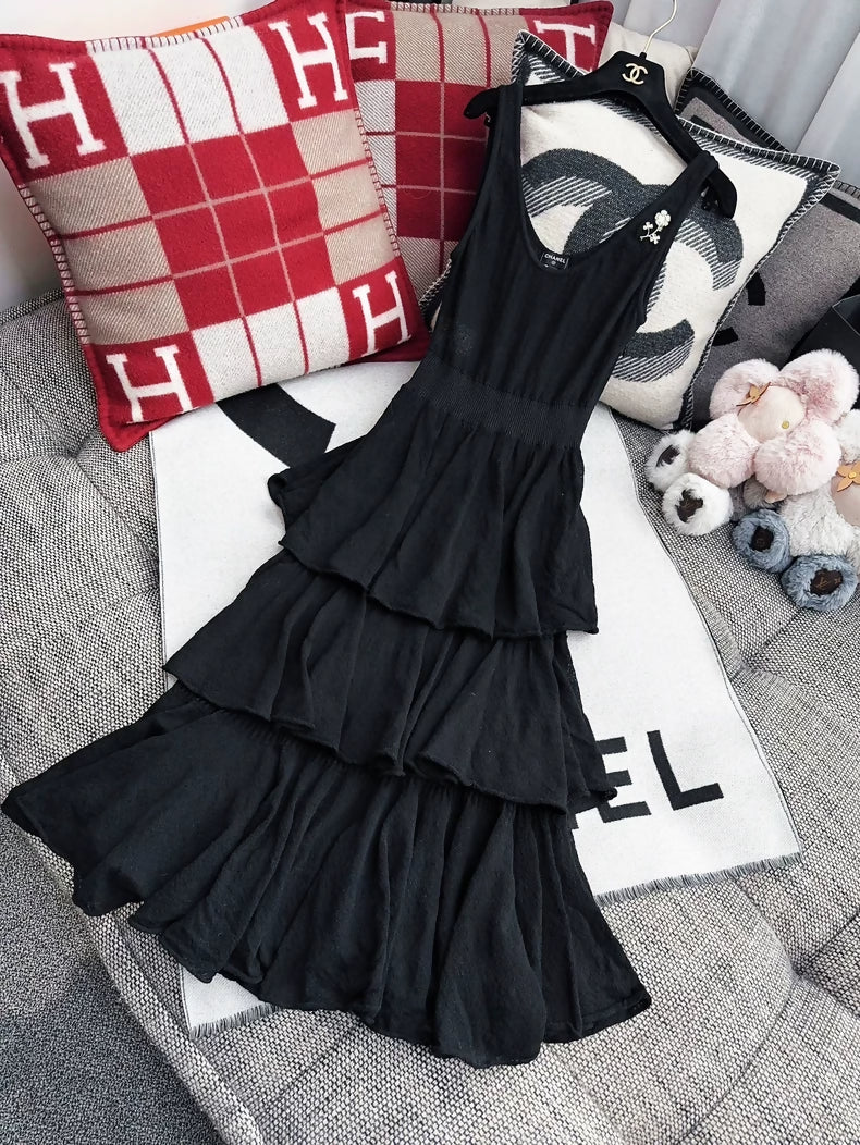 Chanel 25A black dress with camellia brooch