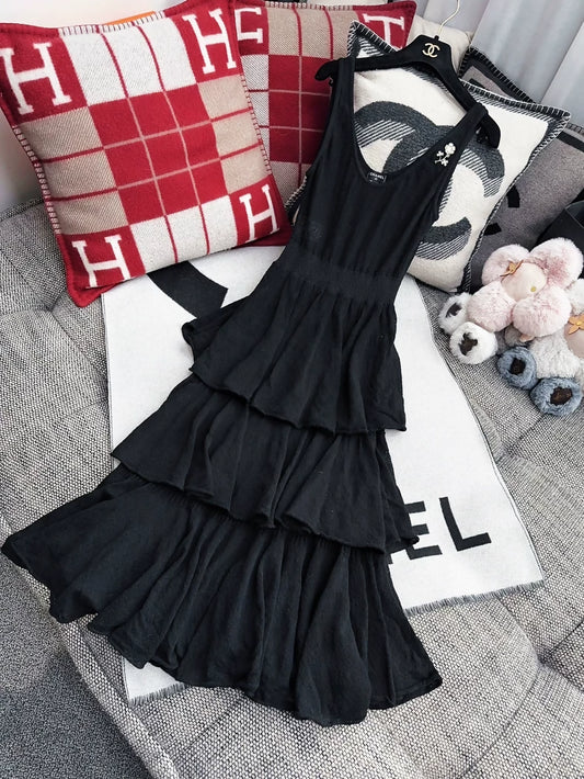 Chanel 25A black dress with camellia brooch