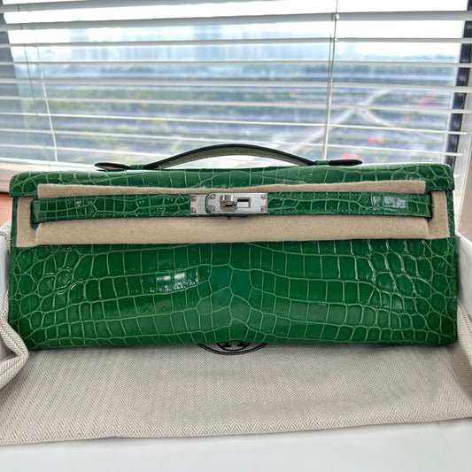 Hermès Kelly Cut clutch in glossy green crocodile with palladium turn-lock and short top handle
