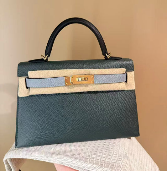 Hermès Kelly mini bag in deep green Épsom leather with pale blue strap, black handle and gold hardware
