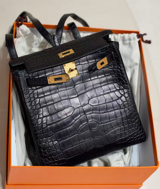 Black matte crocodile-pattern leather backpack with gold-tone turn-lock and strap closure