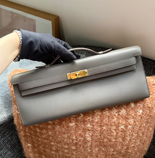 Hermès Kelly Cut clutch in grey smooth leather with gold-tone turn-lock hardware and a slim top handle