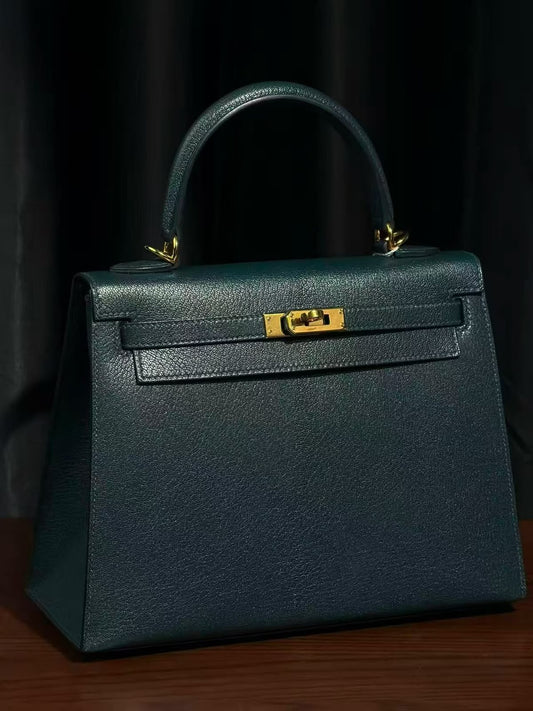 Structured top-handle bag in dark green grained leather with gold-tone turn lock and single rolled handle