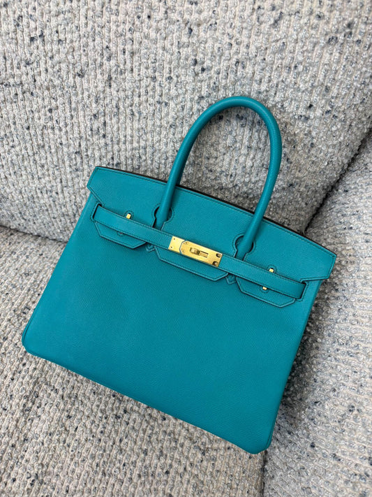 Hermès Birkin handbag in teal blue grained leather with gold-tone hardware, rolled top handle and front straps