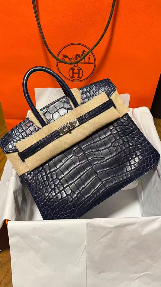 Hermès Birkin handbag in dark navy crocodile-embossed leather with palladium hardware and single rolled top handle