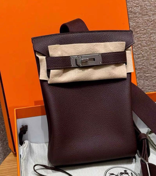 Hermès Kelly-style backpack in dark burgundy grained leather with palladium turn-lock, front strap and wide shoulder strap