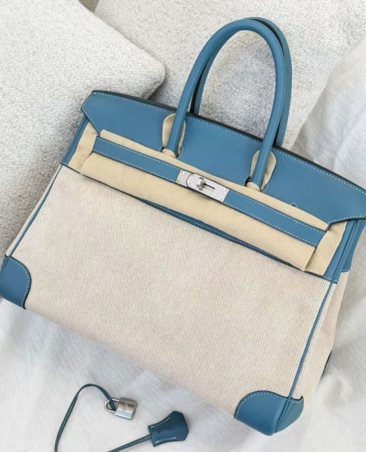 Blue leather and cream canvas Hermès Birkin handbag with palladium hardware, clochette and padlock