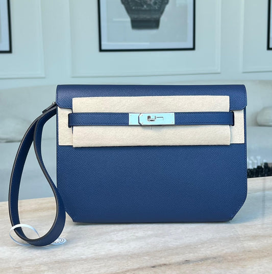 Hermès Kelly Depeches clutch in deep blue grained leather with palladium turn-lock and wrist strap