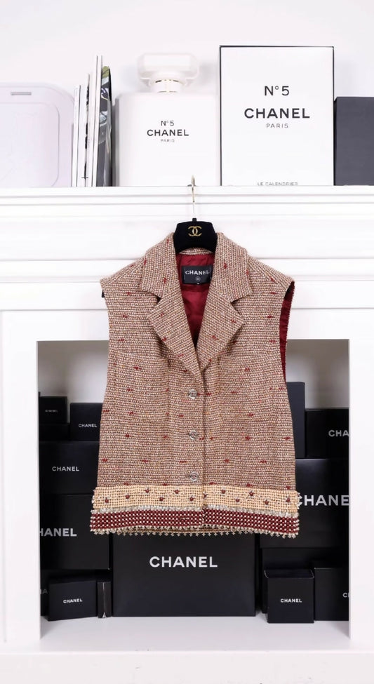 Chanel 23A Dakar Collection Show Style, the same style worn by Wang Yibo. Brown, two-pocket vest with heavy beaded trim.