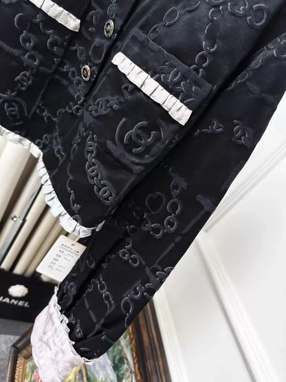 Chanel 22s black embossed double C logo jacket with purple gradient silk trim and two pockets