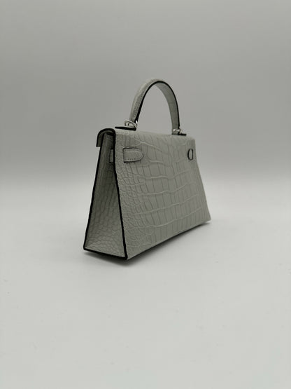 Hermès Kelly 20 Gris Neve Matte Alligator PHW K 2026