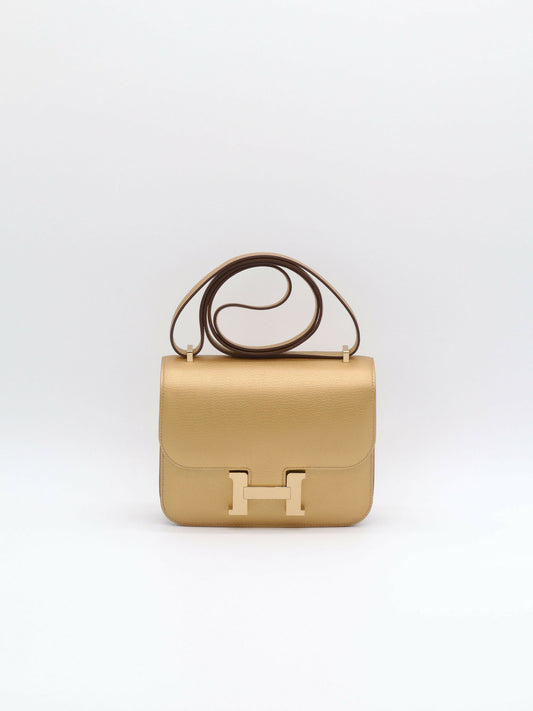 Hermès Constance shoulder bag in metallic gold grained leather with gold H clasp and thin matching strap