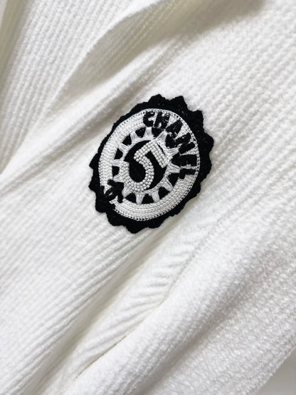 Chanel 23C white ribbed terry knit cardigan with black #5 beaded badge embroidered label