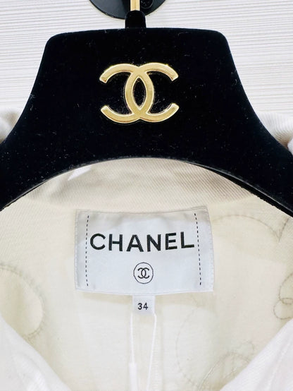 Chanel Métiers d'Art white denim jacket with beaded camellia