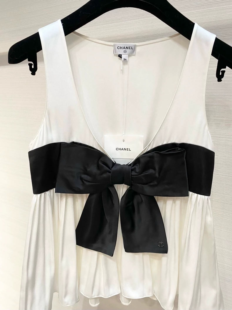 Chanel 25K black and white silk top with bow.