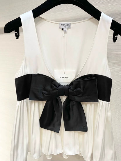 Chanel 25K black and white silk top with bow.