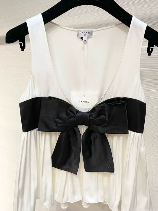 Chanel 25K black and white silk top with bow.