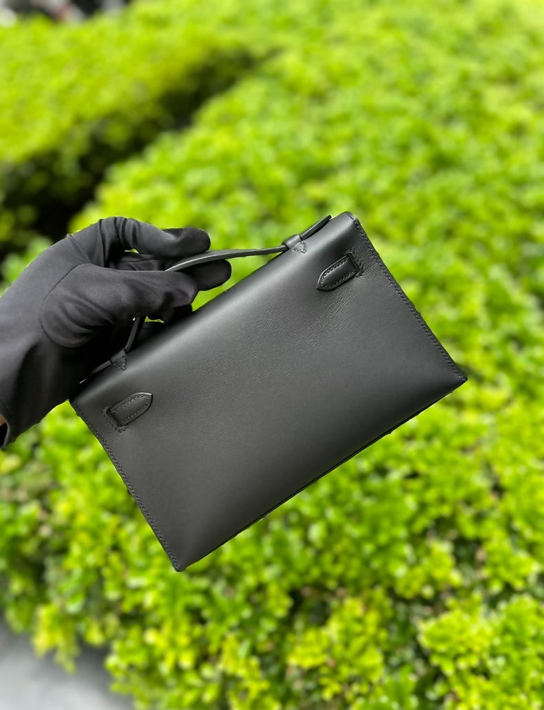 Hermès Kelly pochette black swift leather with light gold hardware