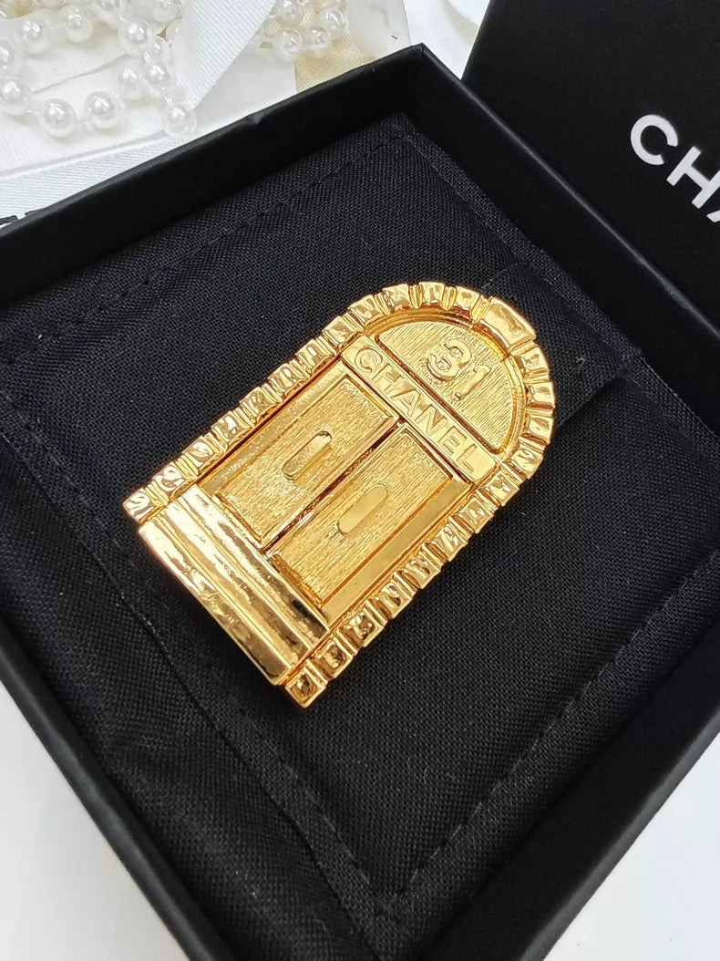 Chanel gold brooch with "31 Rue Cambon"