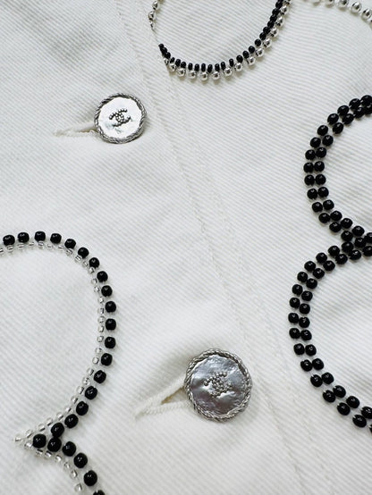 Chanel Métiers d'Art white denim jacket with beaded camellia