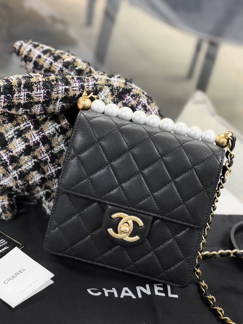 Chanel, black quilted pearl-trimmed vertical chain bag,