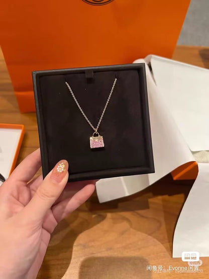 Hermès Kelly bag diamond and pink sapphire pendant necklace